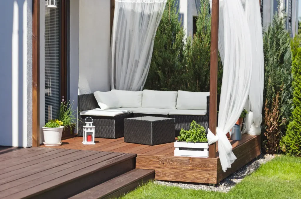 Auf der Terrasse bieten Vorhänge einen leichten Sichtschutz.