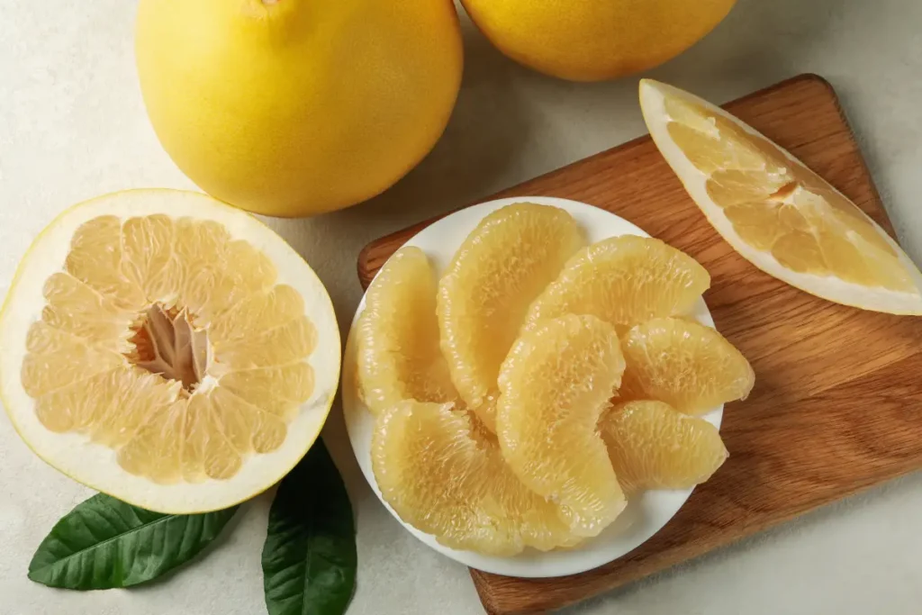 Aufgeschnittene Pomelo und Fruchtfleisch Pomelo pflanzen, pflegen und vermehren